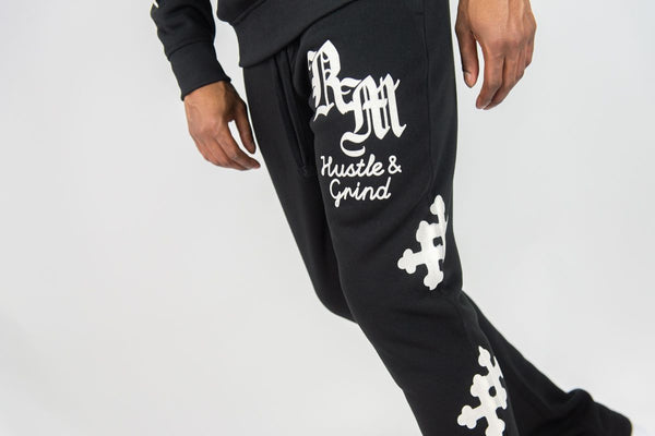 MEN BLACK REBEL CROSS FLEECE STACKED PANTS